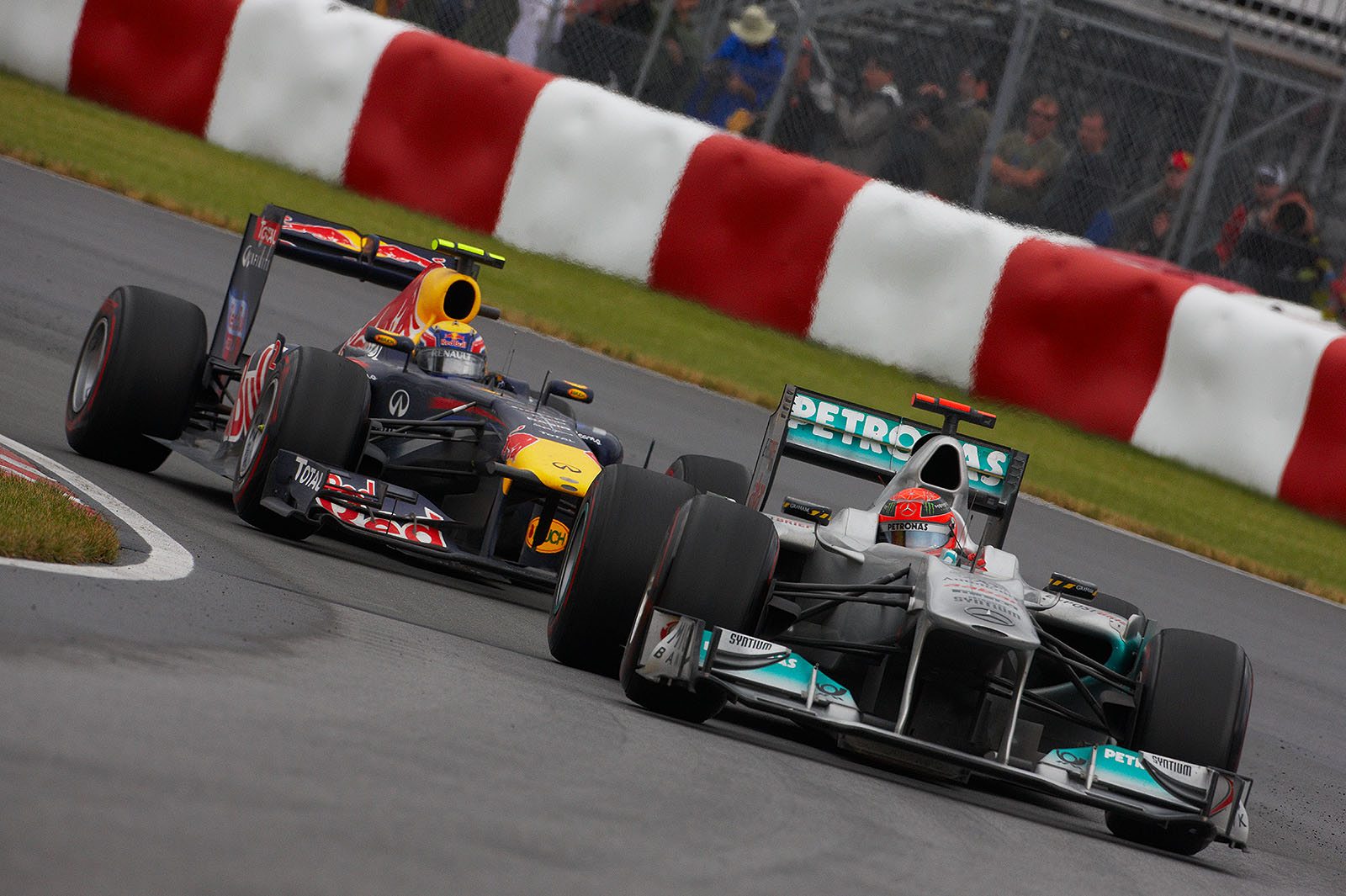 Michael Schumacher, Mercedes GP, with an attacking Webber in his neck