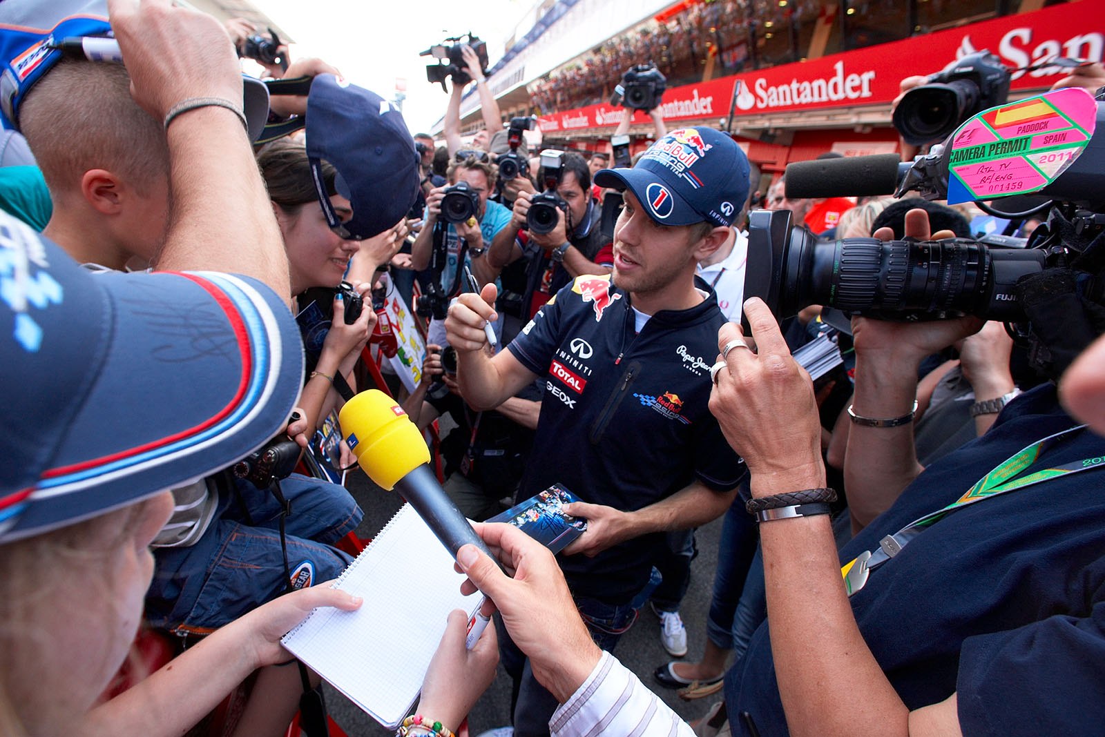 Sebastian Vettel joins other drivers in obligatory fans-meet-the-drivers autograph session.
