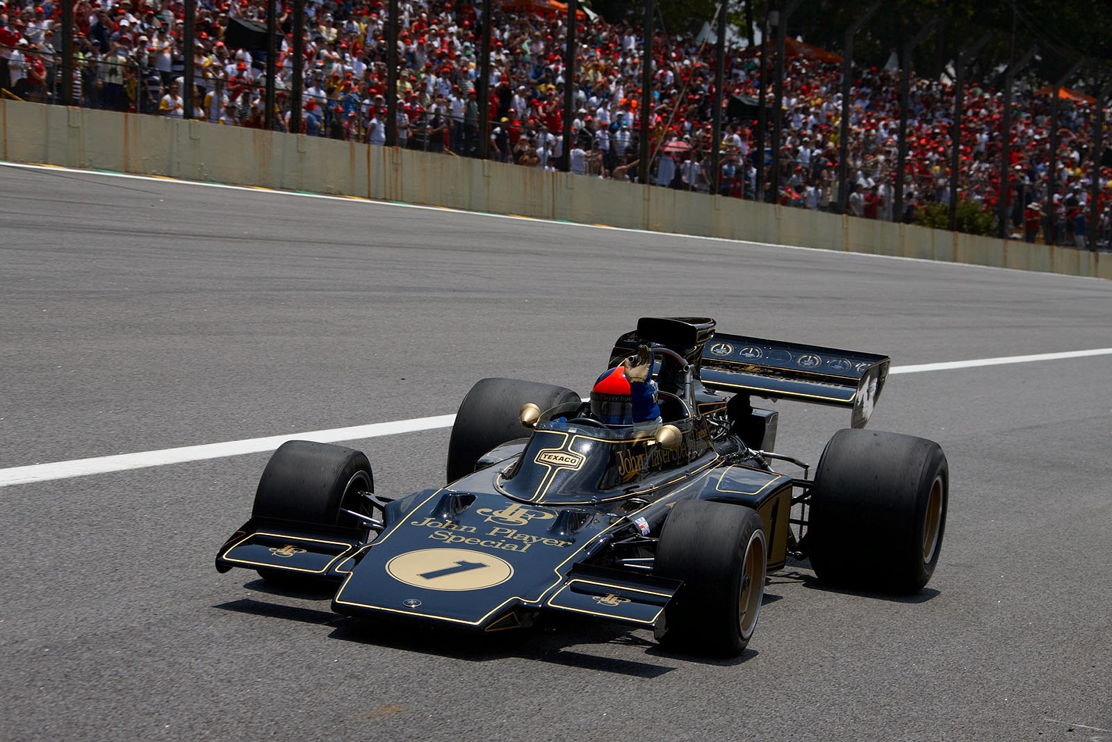 Emerson Fittipaldi showcasing the famous Lotus 72 motor car.