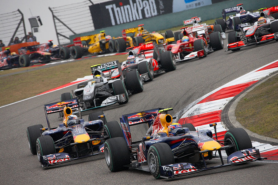 Mark Weber takes the first chicane as second in front of team mate Vettel who lost his pole position