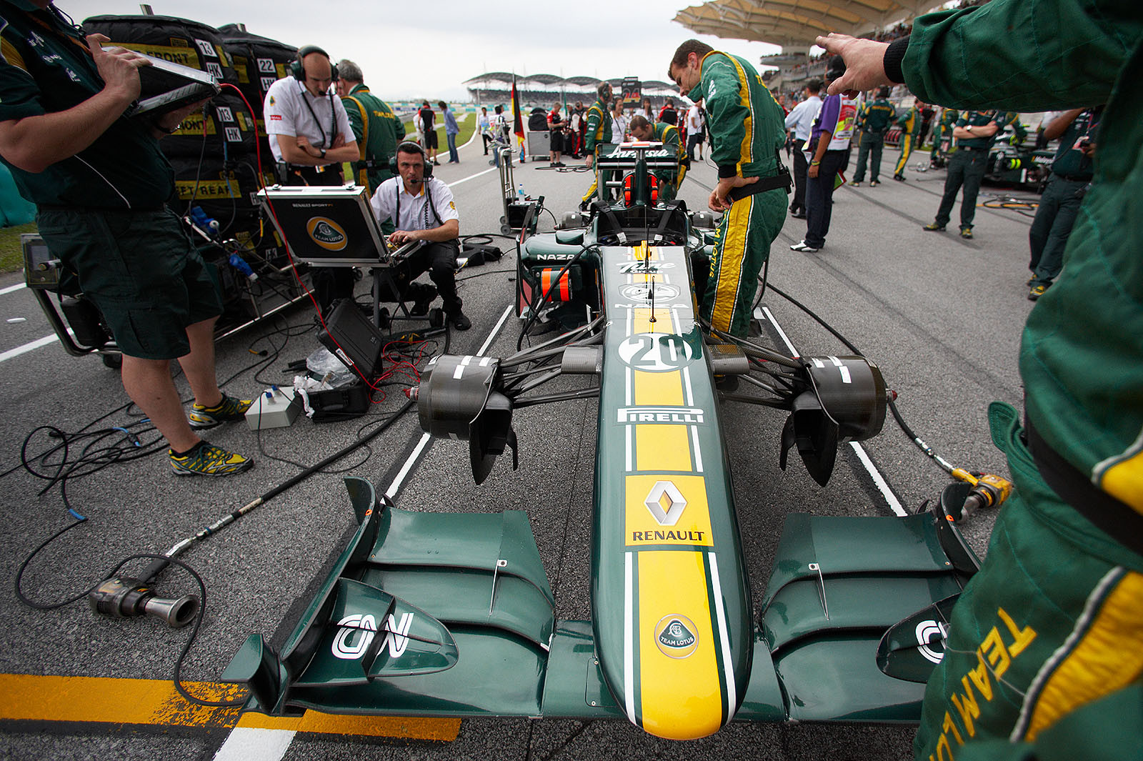 Heikki Kovalainen's Lotus is prepared on the grid before the race