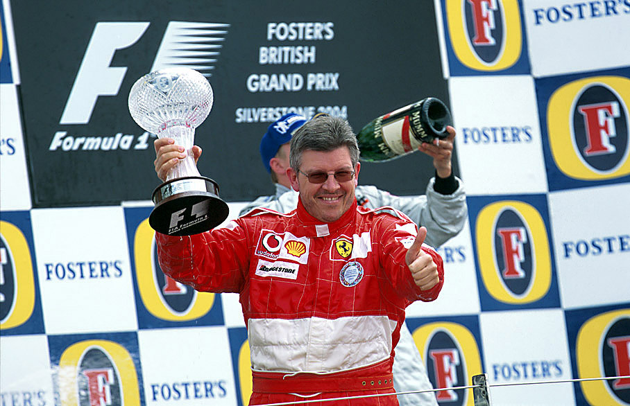 Ferrari's Ross Brawn celebrates at the podium ceremony of the 2004 British GP