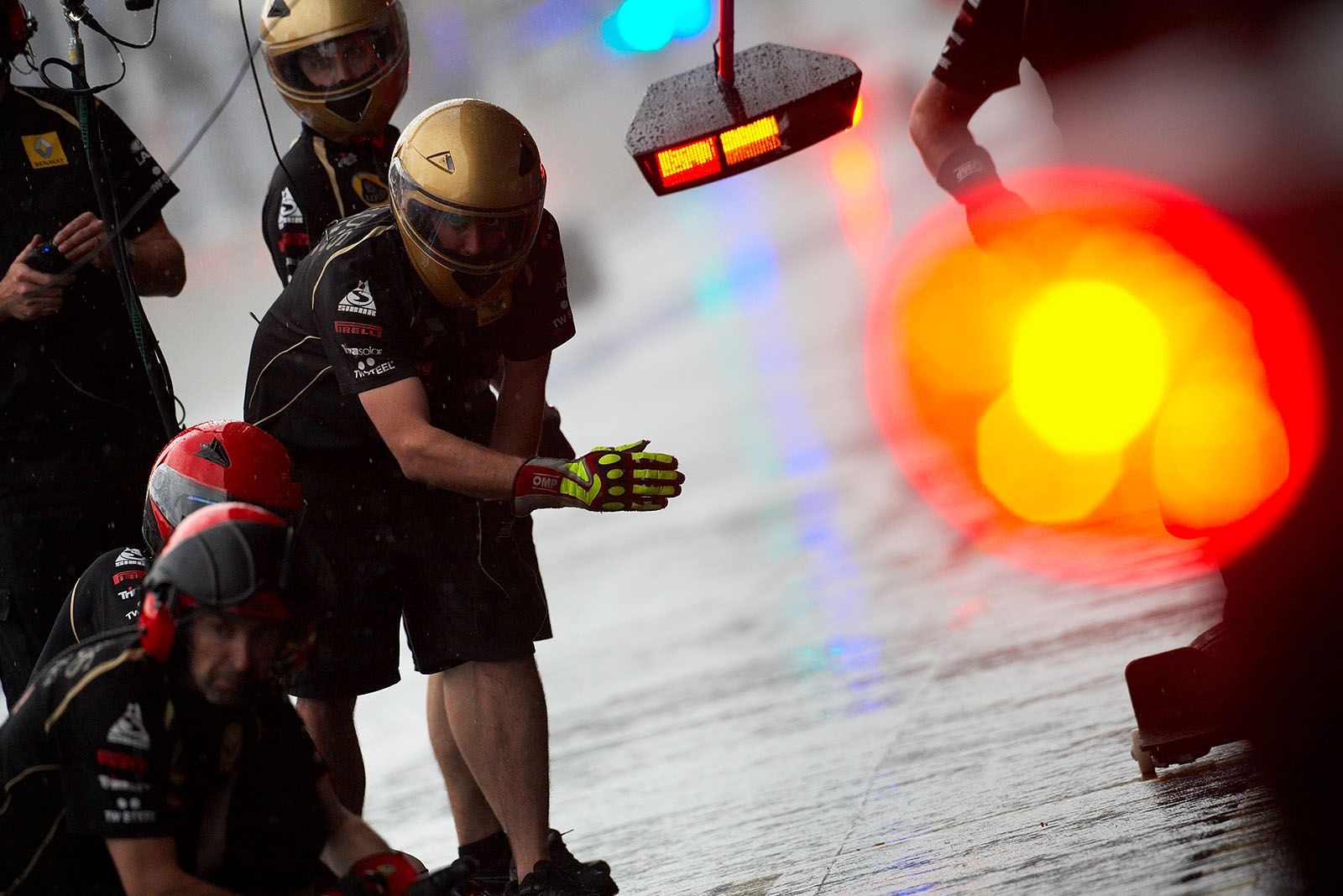 The Lotus Renault GP pit crew waits for their driver