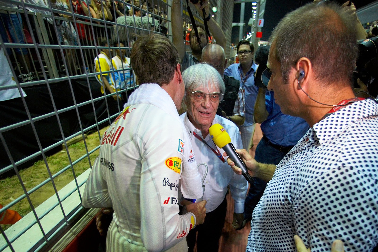 German RTL TV's Kai Ebel interviews Bernie Ecclestone and Sebastian Vettel on the grid before the race