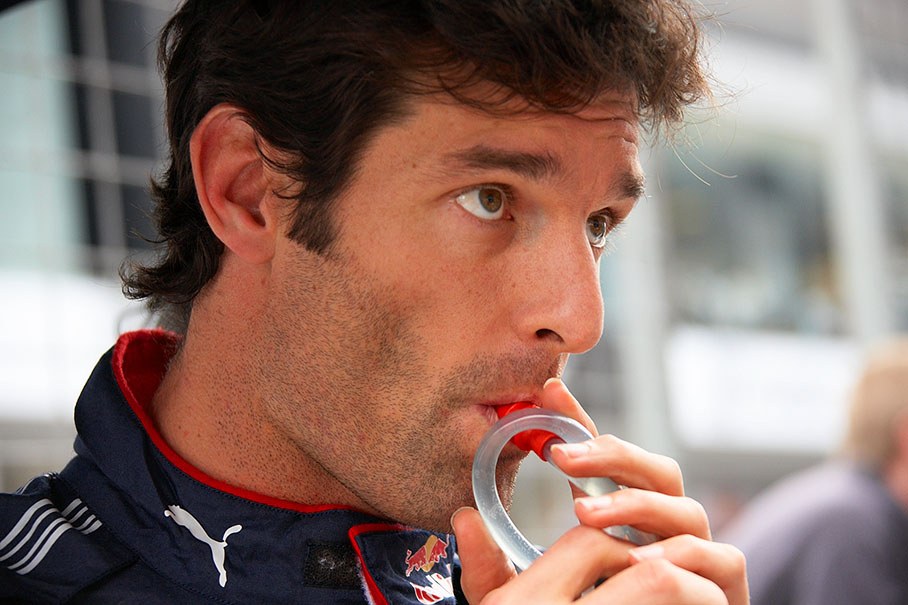 A thoughtful Mark Webber on the second grid position takes a sip of minerals minutes before the race