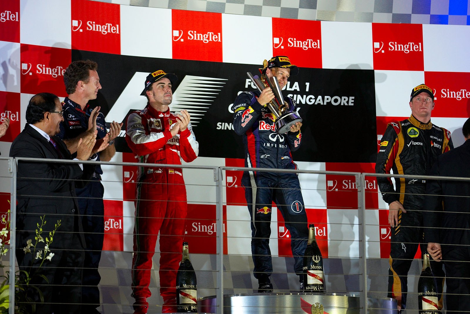 Grand Prix winner Sebastian Vettel gets applause from 2nd placed Fernando Alonso and boos from the crowd for yet another victory this season