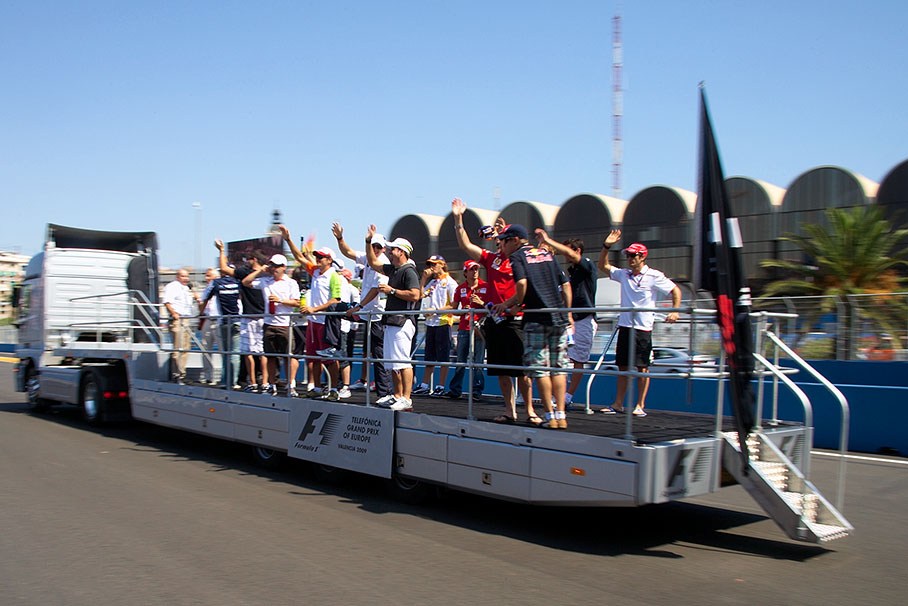 The drivers wave at the grandstands from the driver parade truck