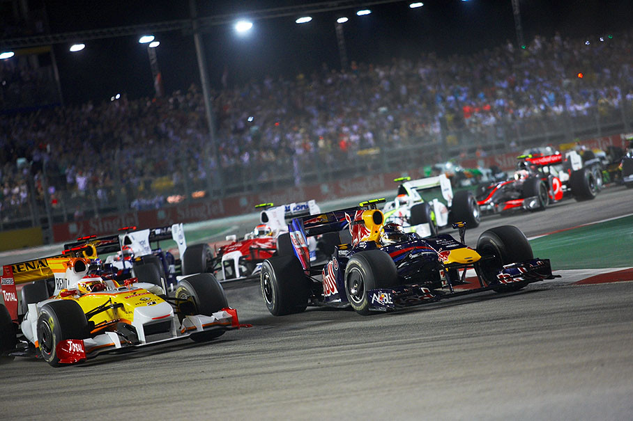 As the start field passes the first chicane, Renault's Alonso fights for the third position with Vettel