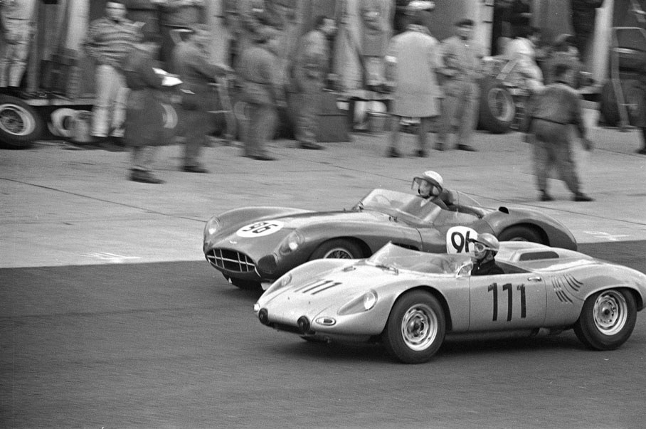 Hans Herrmann in his works-Porsche 718 WPS overtakes Tony Maggs in the &#13;John Ogier-entered Aston Martin DBR1/300 for 4th place.