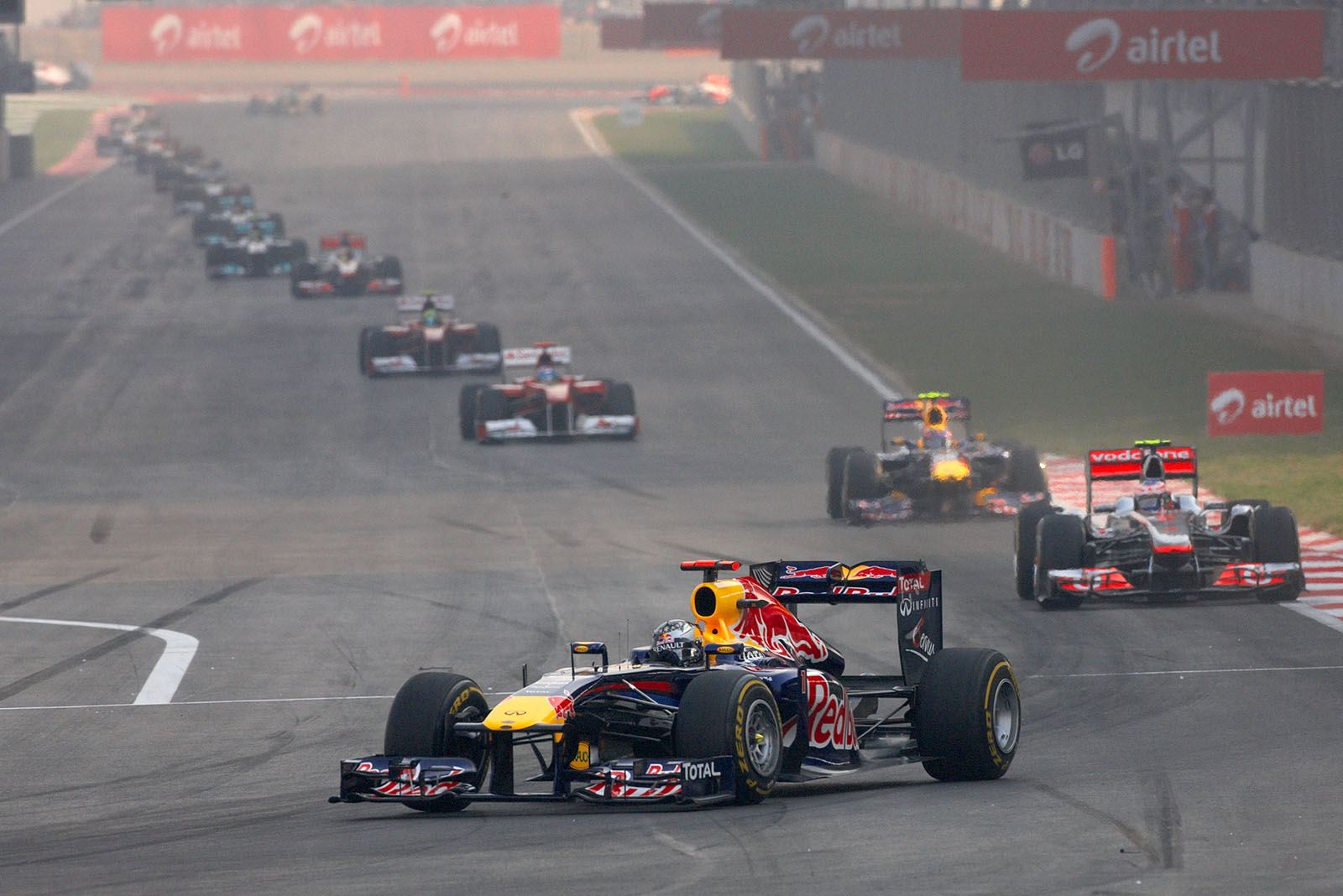 Sebastian Vettel leads the row of race cars after one lap