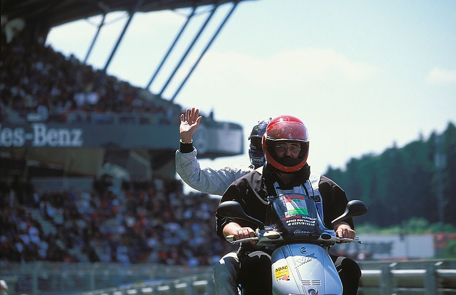 David Coulthard greeting Mercedes fans on his way back to the pits