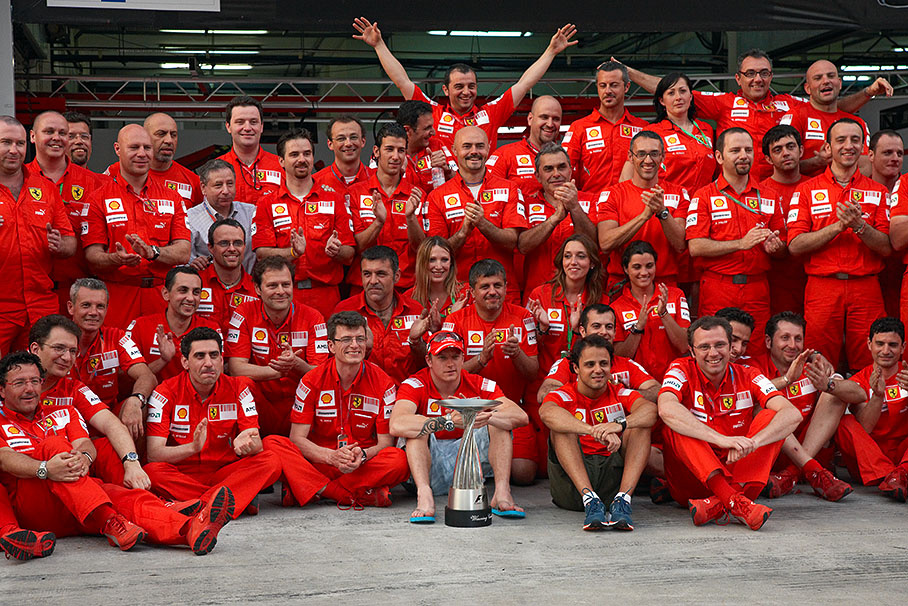 Cheering red Ferrari team group photo