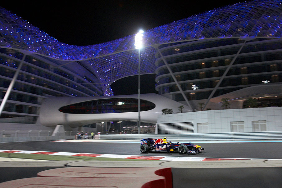 Sebastian Vettel, Red Bull Racing, in front of the illuminated Yas Marina Hotel.
