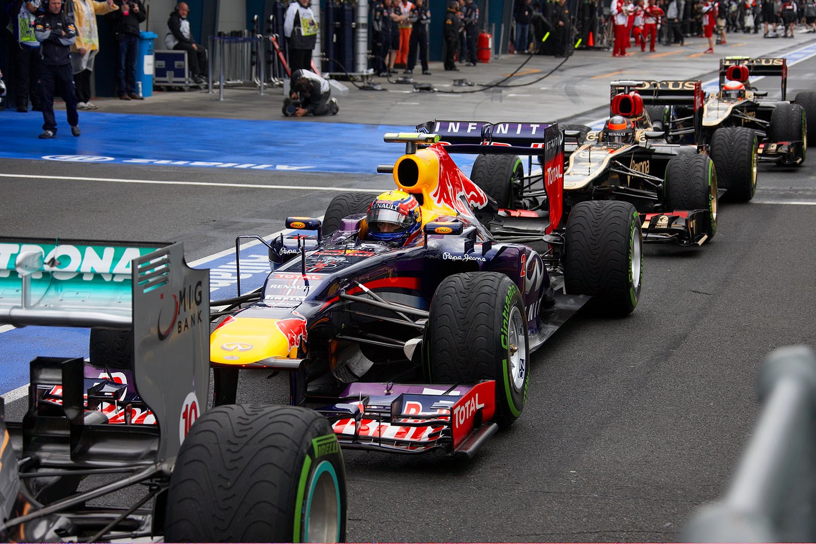 Mark Webber, Red Bull Racing, waits in line with other race cars for the beginning of the postponed qualifying on Sunday morning