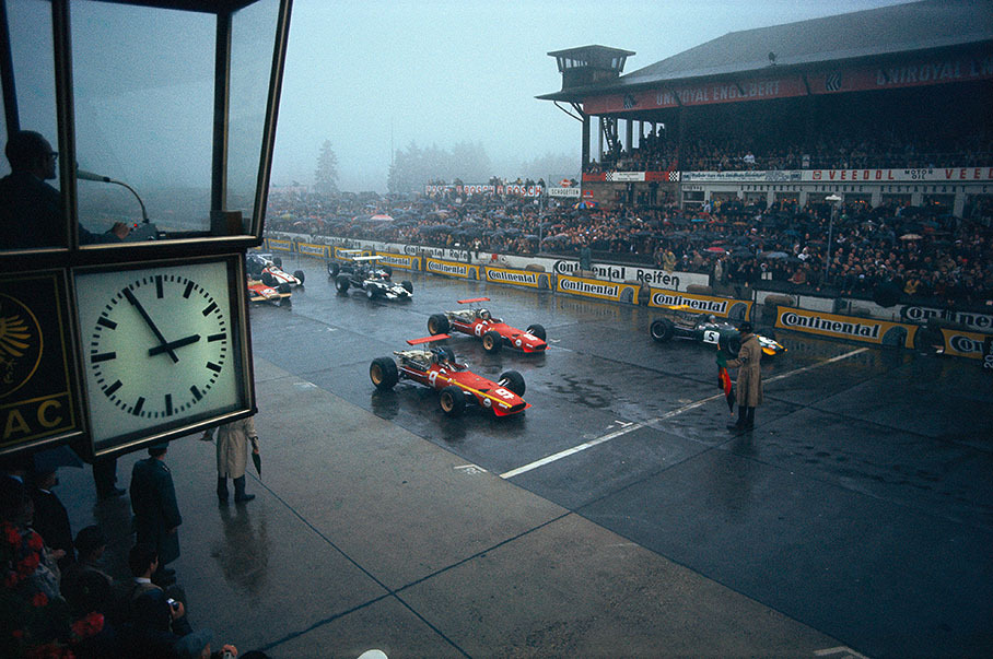 Jacky Ickx (No 9) on pole position in his Ferrari,  Chris Amon (Ferrari, No 8) on second and Jochen Rindt at third starting place in his Brabham - on a rainy grid at the Nuerburgring in 1968.
