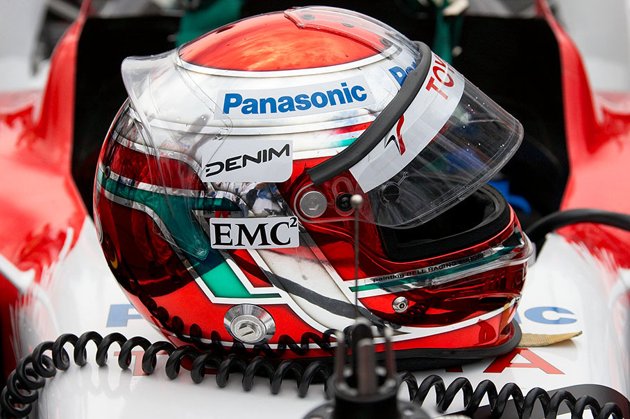 Trulli's shiny helmet rests on his Toyota car on the grid