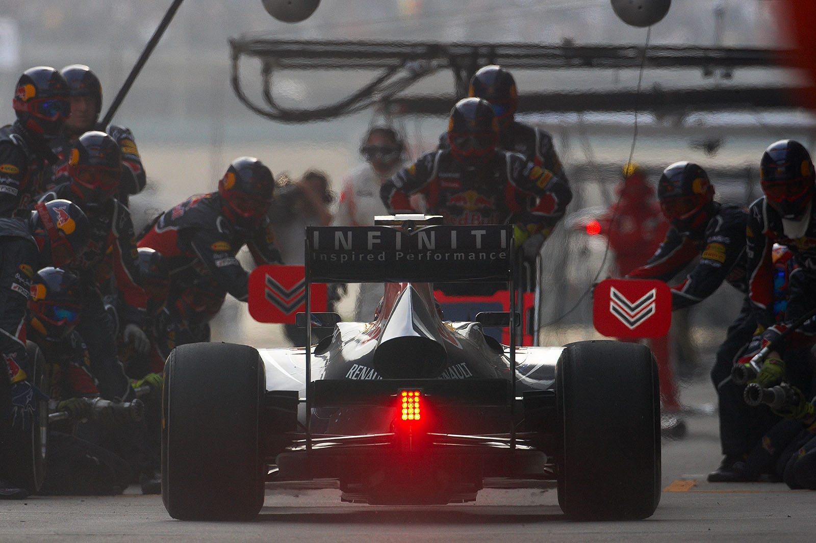 Mark Webber enters the Red Bull Racing pits for a service