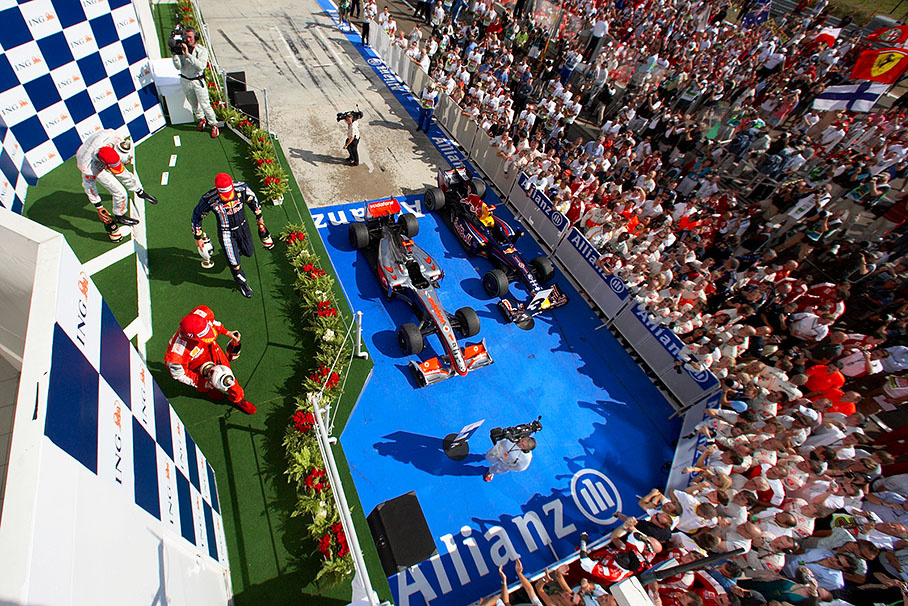 After podium ceremony the winner Lewis Hamilton, second placed Kimi Raikkonen and third placed Mark Webber leave the podium