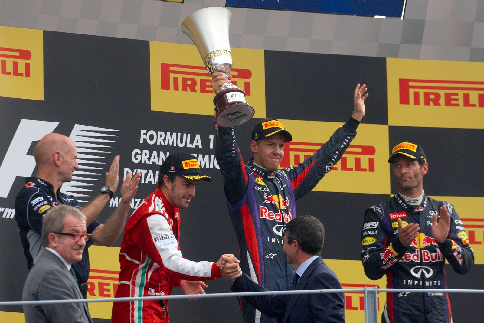 RBR's Sebastian Vettel wins the Italian Grand Prix in Monza 2013 and presents his trophy at the rostrum during the podium ceremony after the event