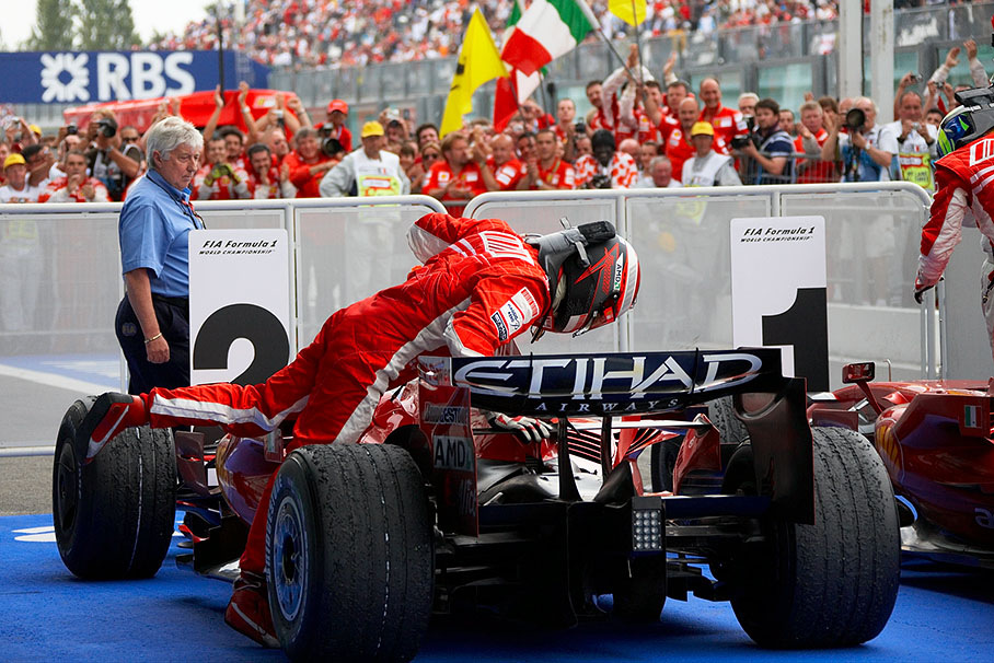 Finally arrived second in parc ferme, Raikkonen checks his Ferrari's exhaust for visible damage