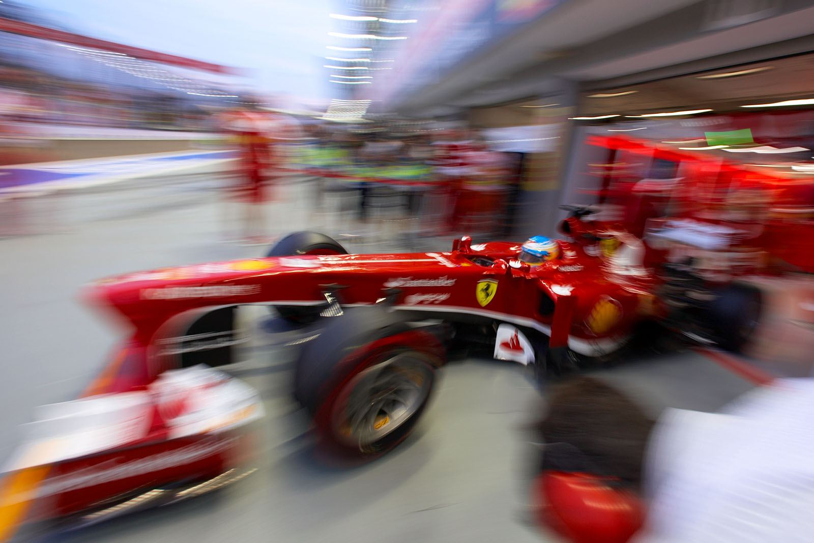 Fernando Alonso, driving his Ferrari out of the pits