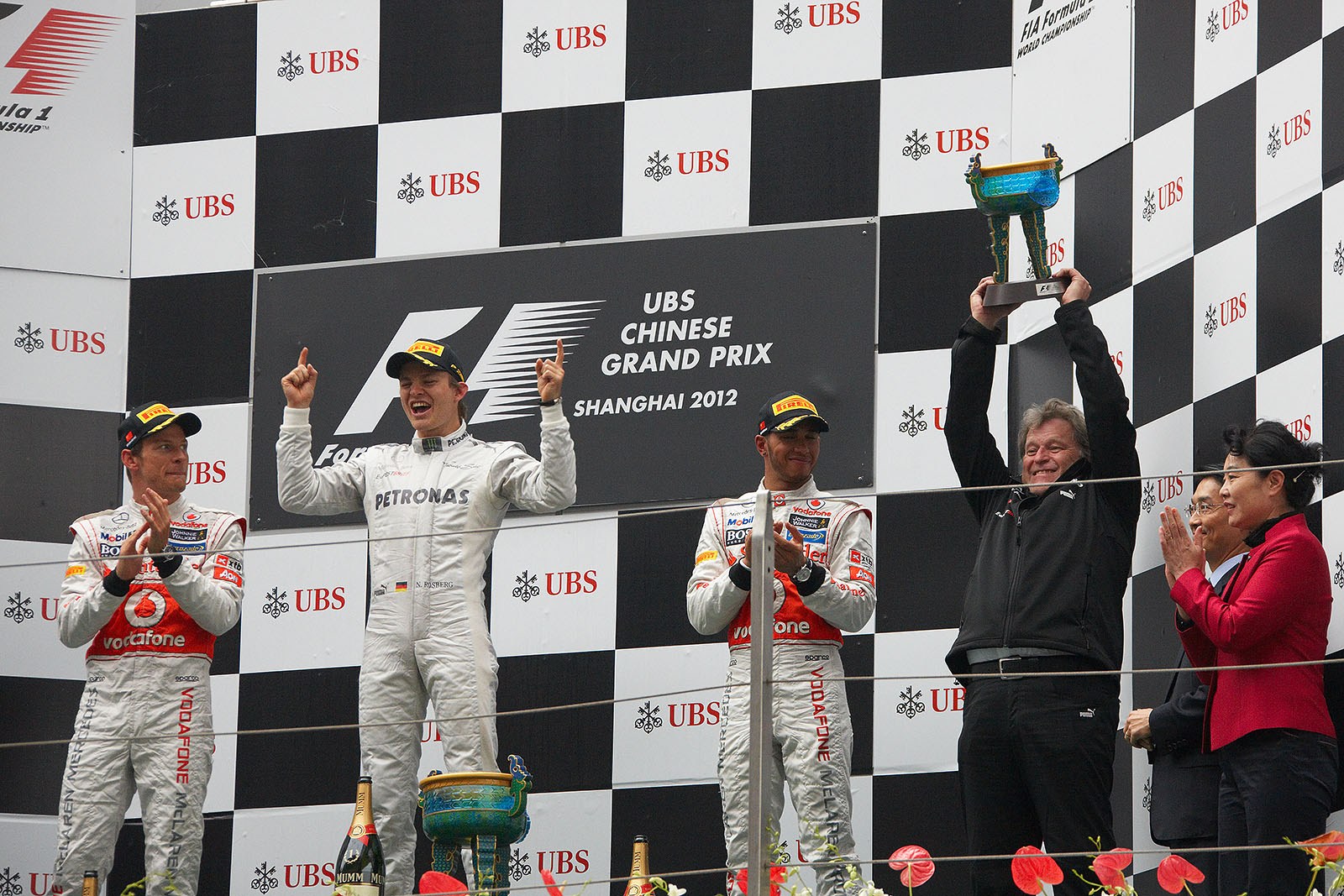 A delighted Mercedes motorsport director Norbert Haug shakes the constructors trophy on the podium
