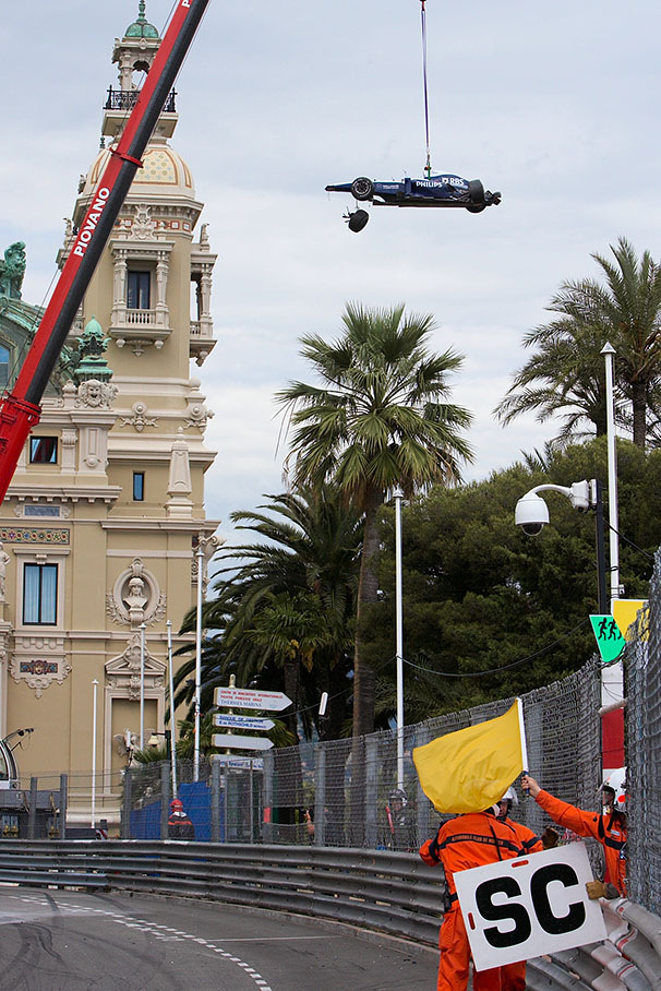 Barrichello's damaged Williams-Cosworth is being taken out of the race