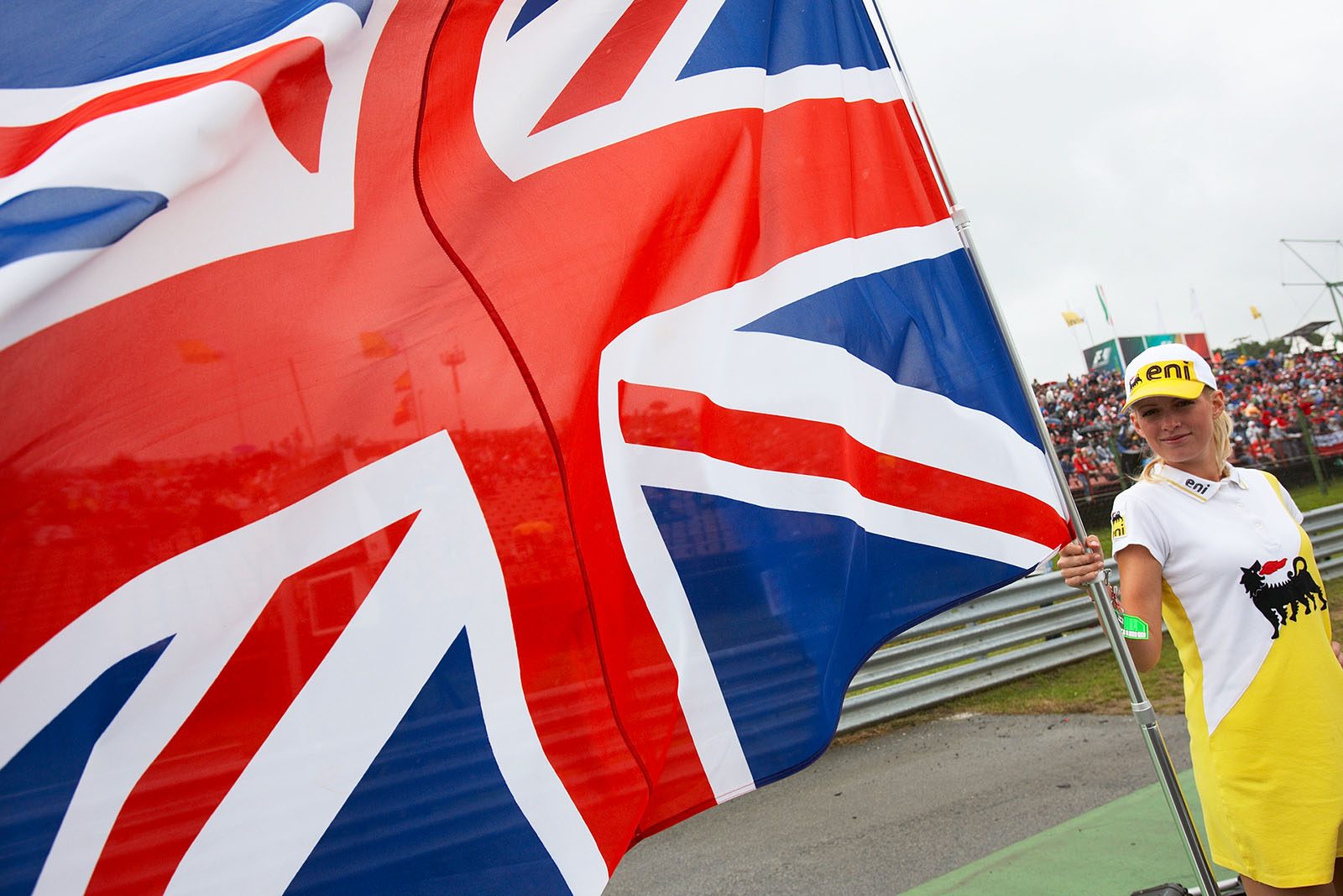 A grid girl holds the Union Jack