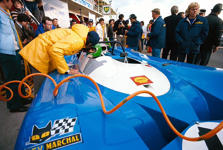 Pescarolo in the pits during practice, being watched by codriver Graham Hill (behind the Matra)