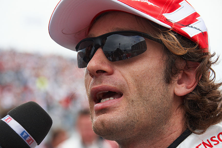Jarno Trulli is being interviewed on the grid