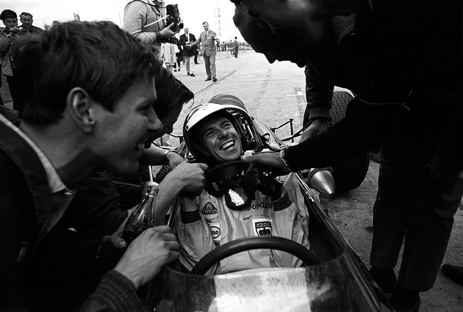 Lotus owner Colin Chapman and chief mechanic Jim Endruweit congratulate Jim Clark for his first and only German GP victory 1965