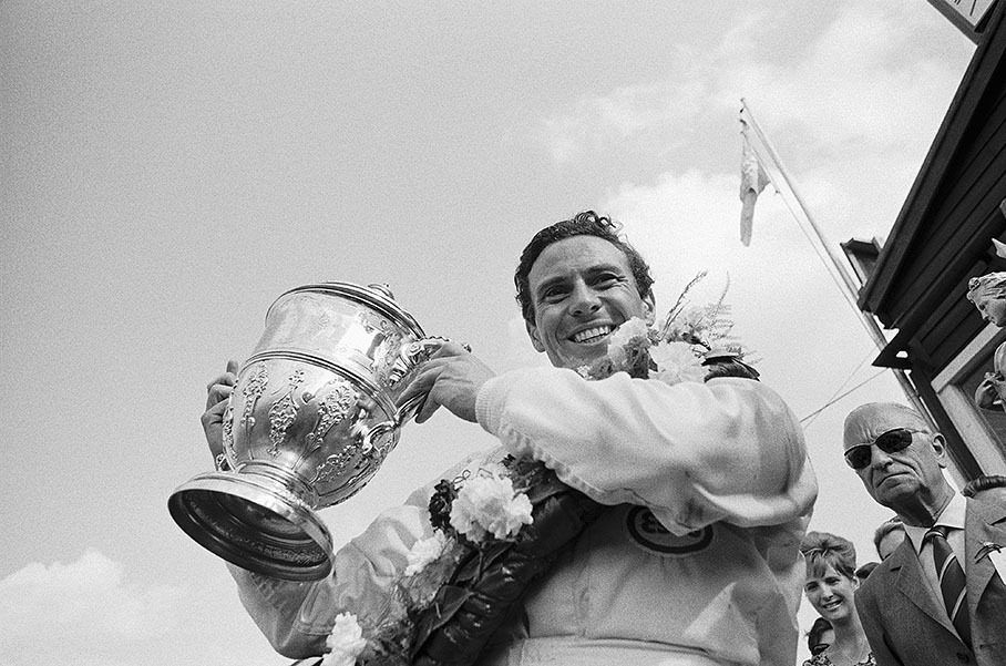 A happy Jim Clark presents his winner's trophy