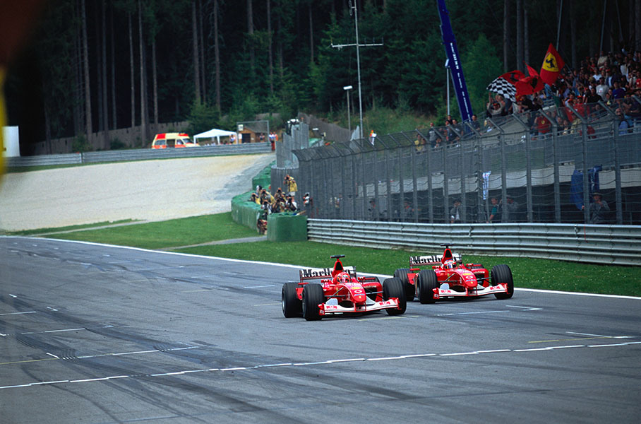 Controversal team order: Michael Schumacher overtakes Ferrari team-mate Rubens Barrichello just before the finish line with 10 races still to go