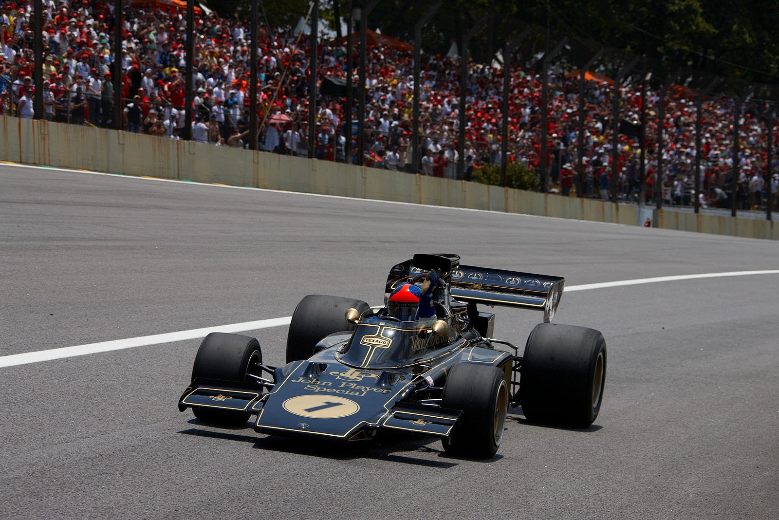 Emerson Fittipaldi showcasing the famous Lotus 72 motor car.