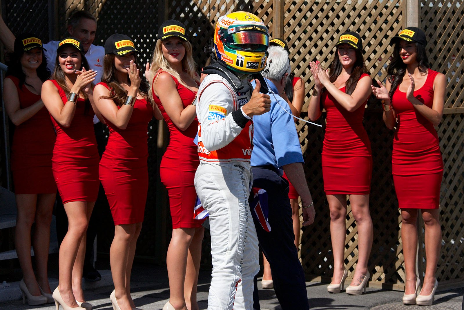 Race winner Lewis Hamilton of McLaren Mercedes celebrates with the grid girls in parc ferme