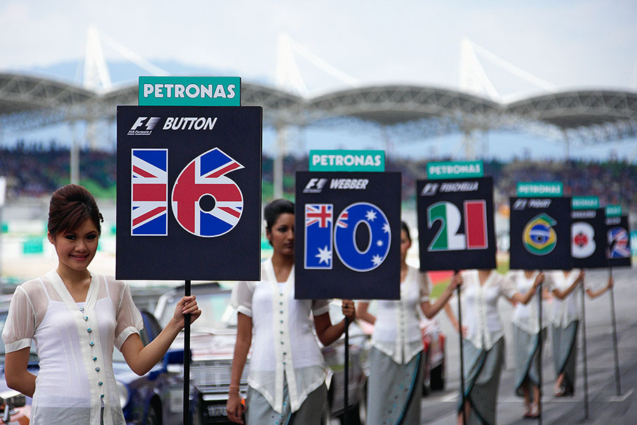 Malaysian grid girls await the drivers for parade