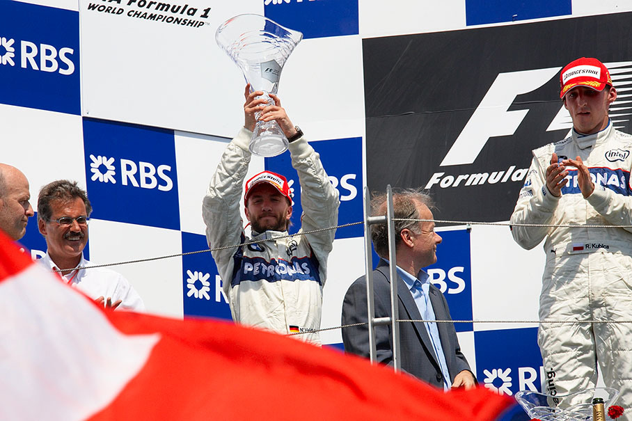 Nick Heidfeld raises his trophy for second place