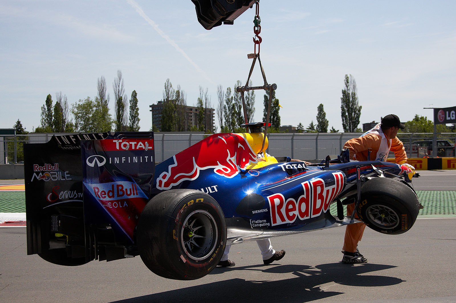 Sebastian Vettel's Red Bull-Renault is rescued from the track during the first session on Friday morning