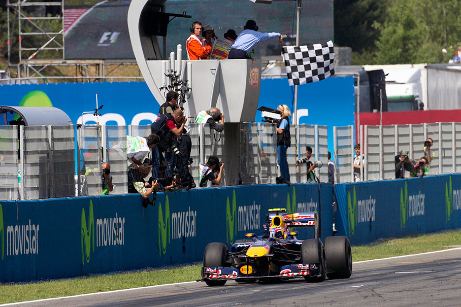 Race winner Mark Webber, Red Bull Racing, takes the chequered flag