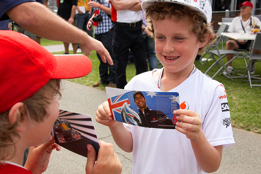 Two proud young fans compare their Webber/Red Bull autograph treasures