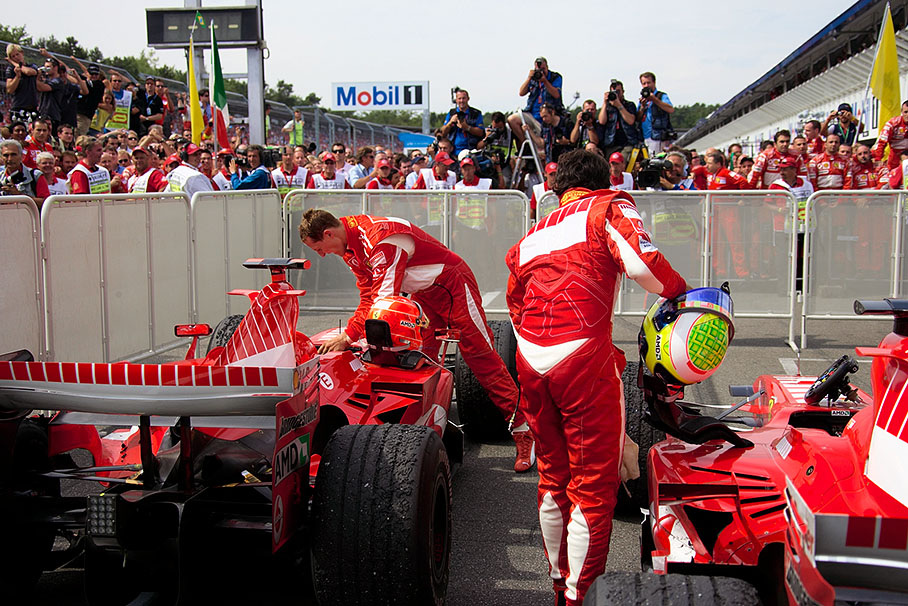Michael Schumacher and Felipe Massa packing their things together for podium ceremony