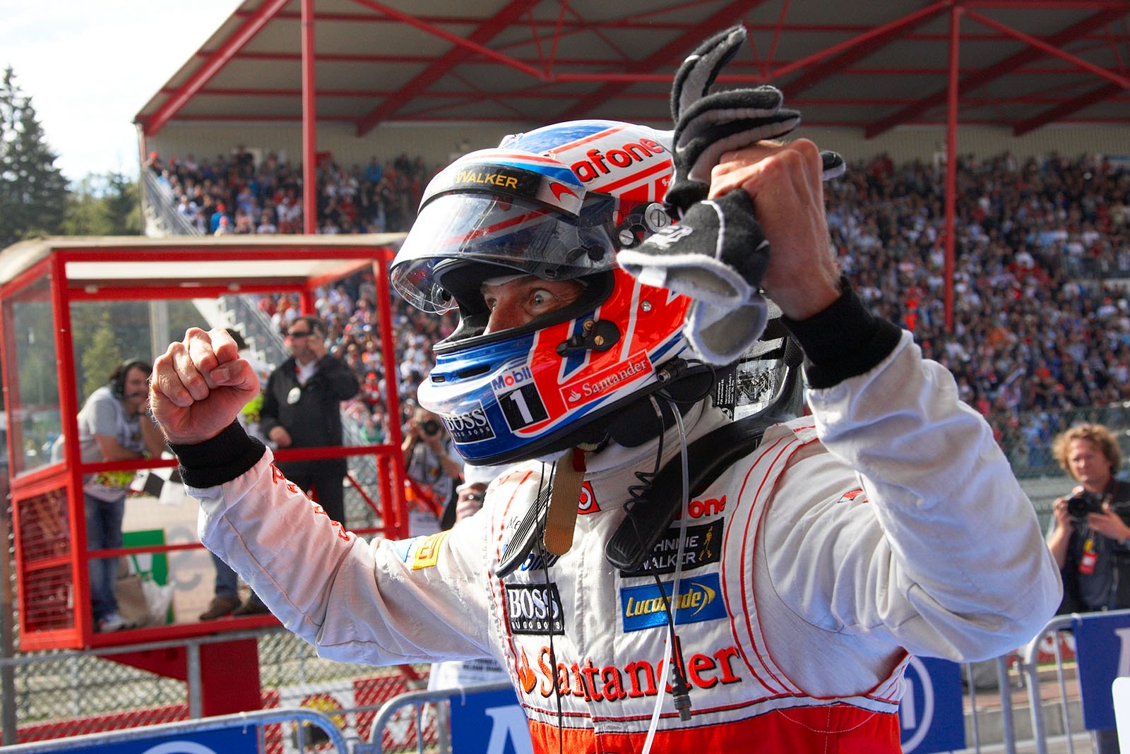Race winner Jenson Button of McLaren celebrates in parc ferme