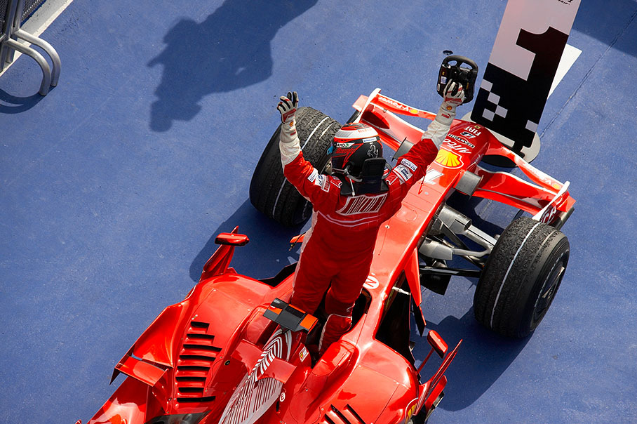 Having arrived in park fermé after a lonely race Raikkonen jumps out of the winning Ferrari