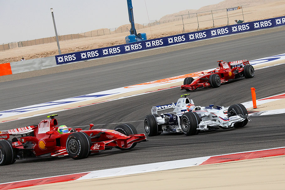 With the other Ferrari giving pressure in the neck, BMW Sauber's Robert Kubica nearly manages to overtake Massa in the inside of the corner