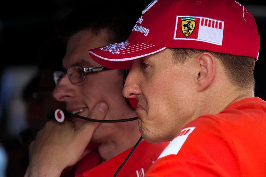Michael Schumacher watching the last 10 qualifying driver's times with his race engineer Chris Dyer