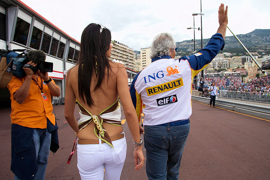 Renault F1 team principal Flavio Briatore walks through pitlane with his girl friend Elisabetta Gregoraci
