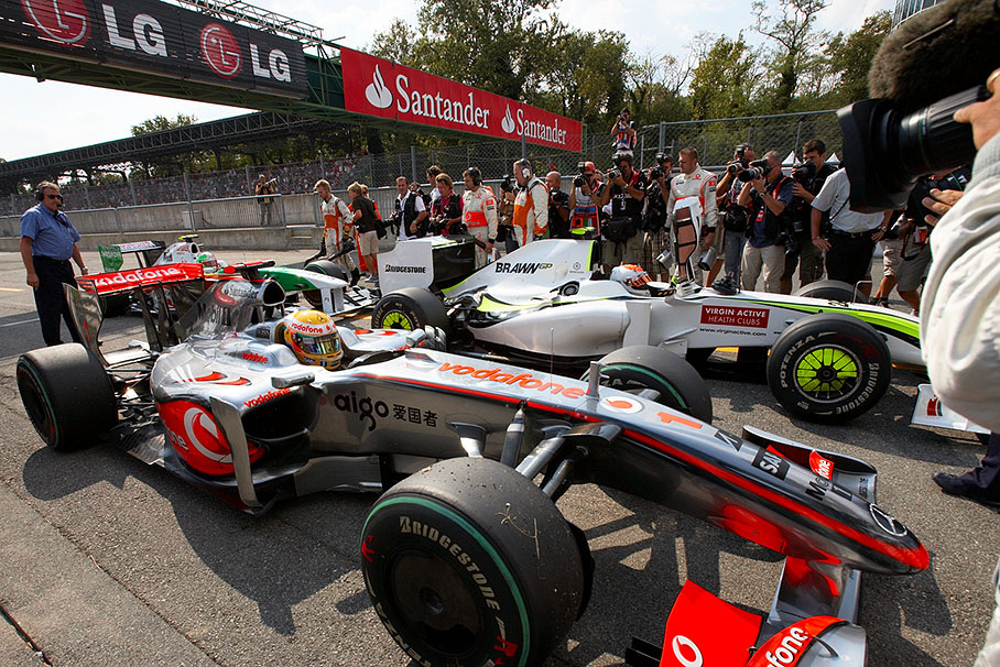 Polesetter Hamilton arrives in parc ferme with the McLaren Mercedes car, flanked by Brawn GP's Rubens Barrichello and Force India's Liuzzi