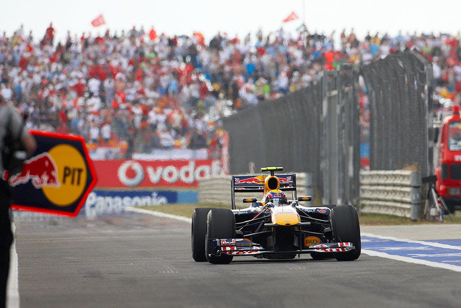 Mark Webber enters pit lane for a brief pit service with a damaged front wing