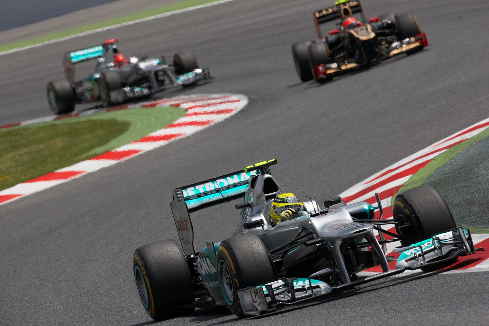 Nico Rosberg, Mercedes GP, in front of Lotus' Grosjean and teammate Schumacher