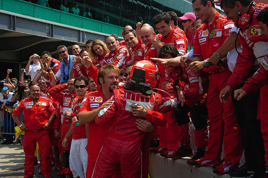 Michael Schumacher hugging his mechanics